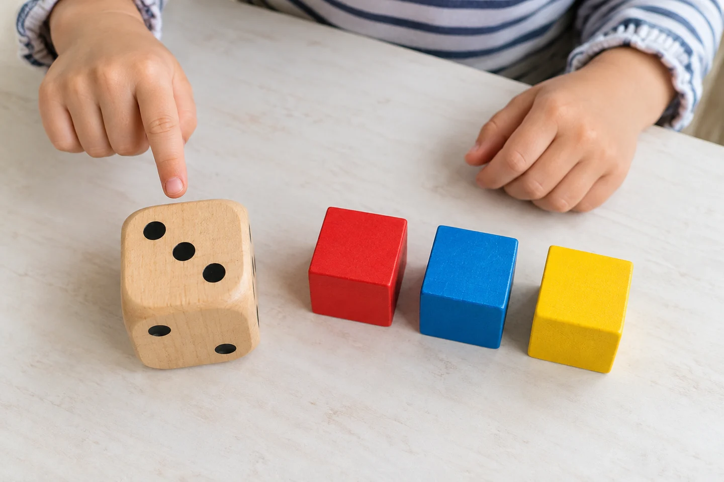 Match a roll of three dots with a group of three blocks.