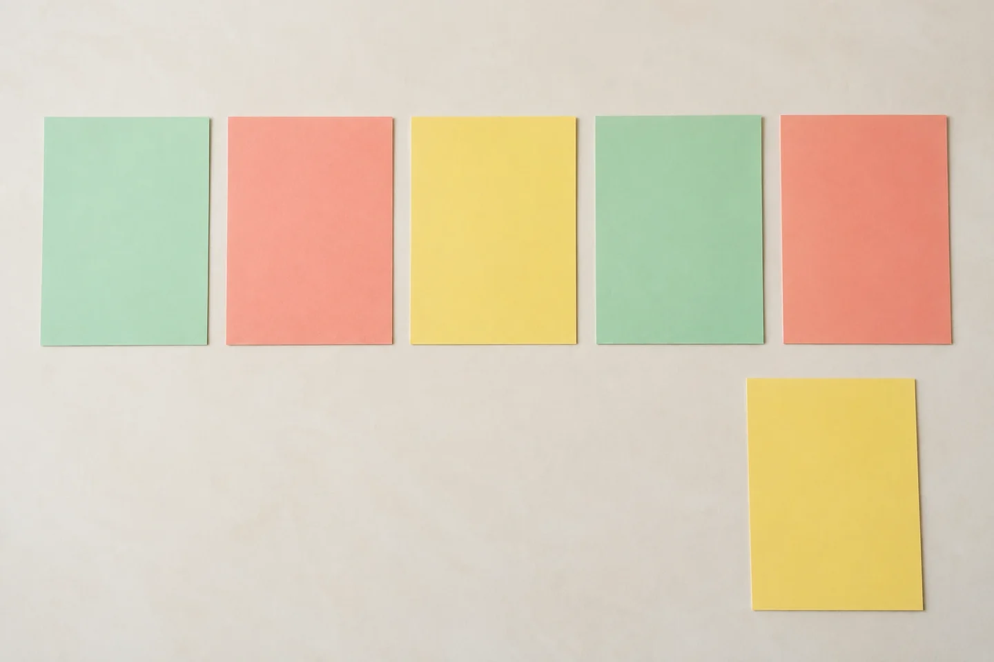 Five blank equal 5 by 7 inch panels in a loose row on table with a spare off to one side
