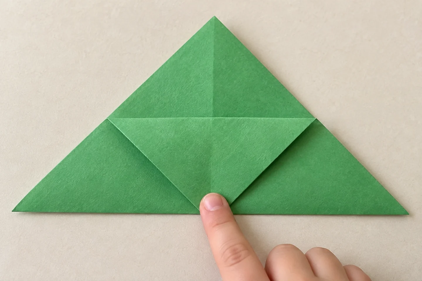 Only the front triangle layer folds down while the back point stays upright.