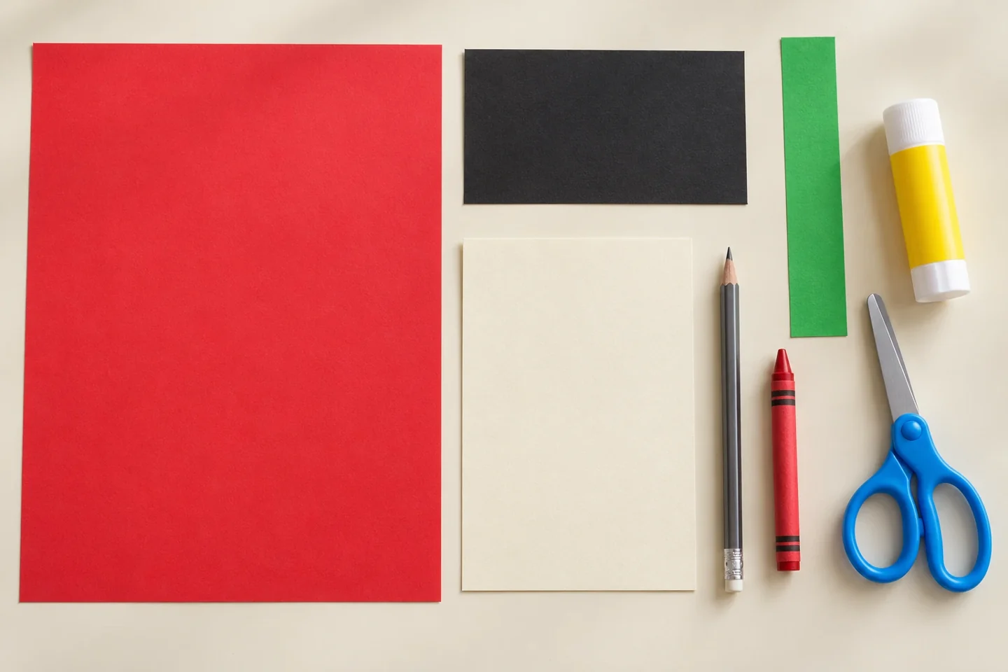 One blank red sheet, small blank dark scrap, one green paper strip, plain cream card rectangle, glue stick, child scissors and pencil or crayons, uncut and unassembled
