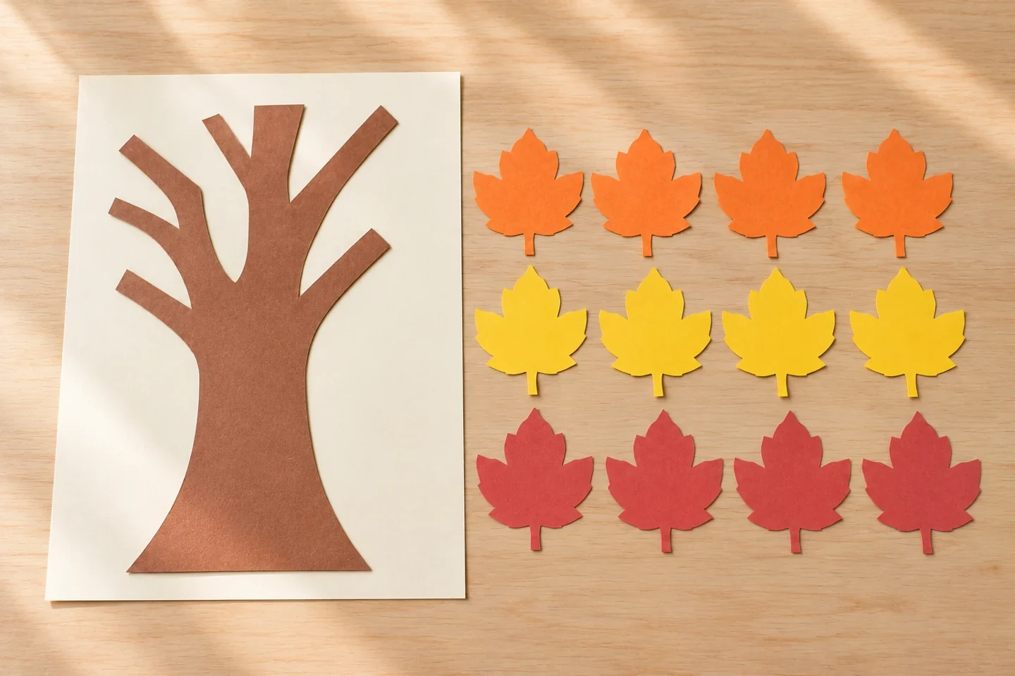 A paper trunk attached to its background beside twelve blank leaves