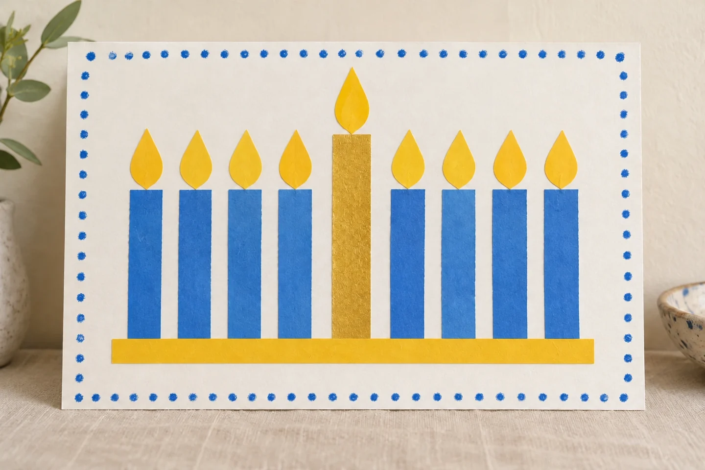 Finished flat landscape collage with exactly eight equal holiday candles, taller central shamash and exactly nine paper flames; no real candles