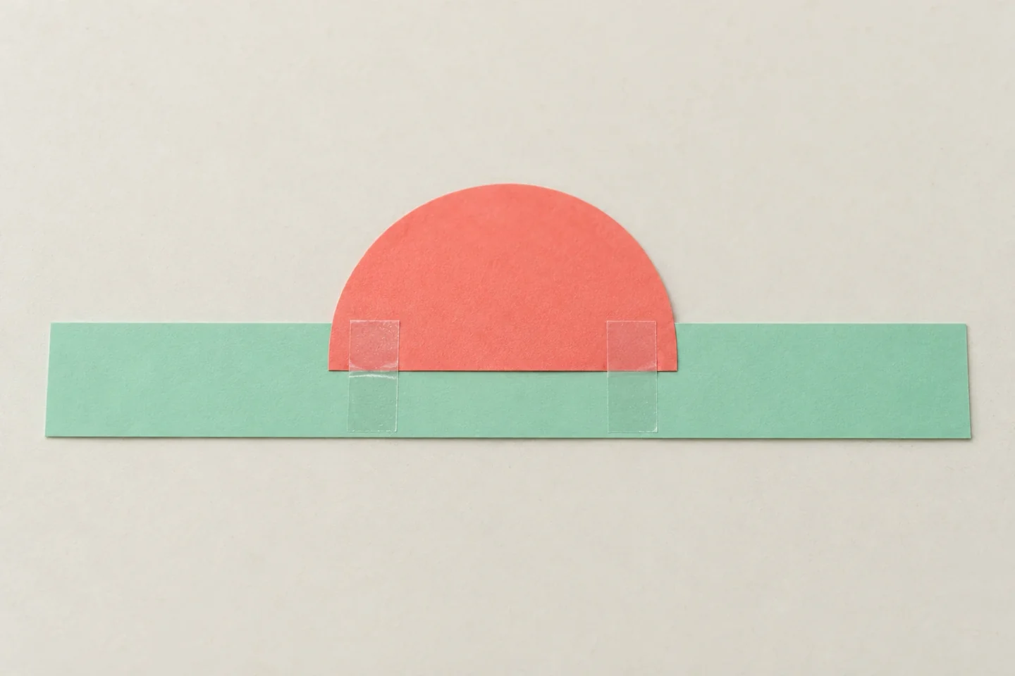Back closeup of coral semicircle straight edge overlapping one inch behind center of flat mint band, glue contact and tape reinforcement visible, band remains unjoined